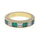 A SUBSTANTIAL 750 hallmarked yellow gold RING size O/P set with four large cut EMERALDS 4mm length