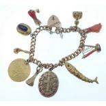 SIMPLY EXQUISITE!!! A VICTORIAN 9ct stamped yellow gold charm BRACELETwith 10 charms, to include