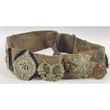 A WWl belt with 15 badges and buttons including SCOTTISH HORSE, ROYAL ARMY MEDICAL CORPS, ARGYLL