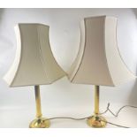 Two similar brass column style table lamps of slightly different heights