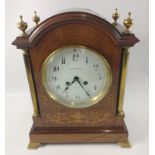 A Sheraton-style bracket clock with marquetry inlay with bracket ogee feet by Edward & Sons,