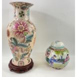 An ORIENTAL vase table lamp base on a wooden raised stand decorated in flora with the hole on