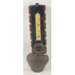 An antique Swiss COW BELL with a leather strap with hand-embroidered decoration