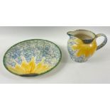 A hand-painted POOLE POTTERY plate (22cm dia) and matching milk jug (height 11cm) in a pattern of
