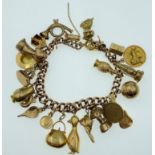LOTS OF CHARMS!A 375 stamped gold charm bracelet , the 375 is partially rubbed, with most charms