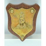 A PIONEER CORPS brass and wooden plaque 12cm long
