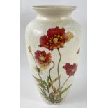 A vintage POOLE vase in cream with a design of poppies, stands 27cm tall