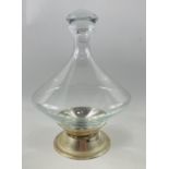 A stylish cone shaped DECANTER with white metal stand, 28cm tall