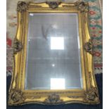 A SUBSTANTIAL OPPULENT ANTIQUE STYLE gilt framed wall mirror - 90cm length x 120cm height -