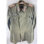 RARE - A WWII GERMAN army artillery officer's summer tunic constructed of a lightweight grey cloth