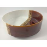An unusual vintage Poole Pottery bowl half brown and half white 20cm dia, 8cm high
