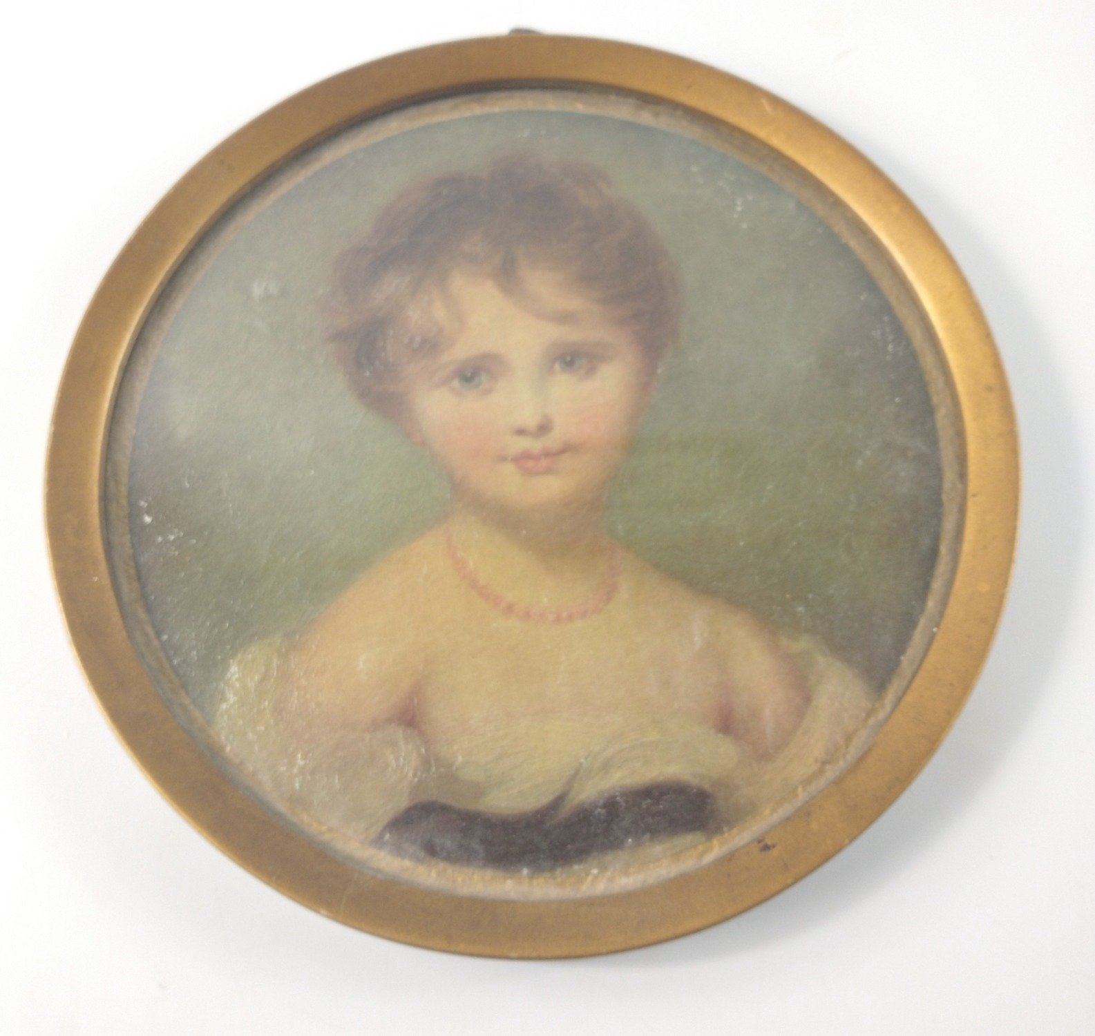 An oil on board circular framed bust of a young girl diameter 22cm