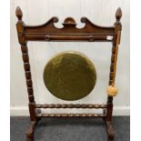 An impressive brass gong to call the family together, stands 94cm high, 65cm wide and the gong