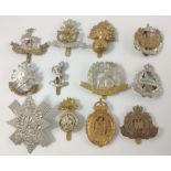 Twelve British military cap badges to include THE ESSEX REGIMENT, THE FORESTERS, THE SUFFOLD