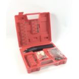 A small battery operated rotary hand-held tool with accessories within