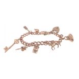 A gold 375 charm bracelet with 7 charms, six of which are stamped 375, bracelet length approx