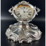 A Goliath clock in a hallmarked silver stand Birmingham 1906, gross weight of stand 380g, watch