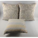 Three nice cushions, two in shades of light grey and cream 48cm square approx, and a slightly