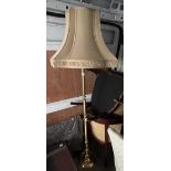A large brass style standard lamp with shade