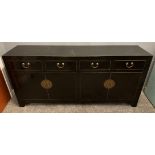An ORIENTAL HIGHLY decorative black distressed-painted lacquered large four drawer and four door
