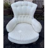 A VINTAGE soft upholstered easy chair