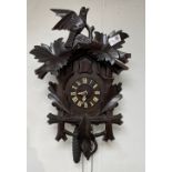 A large sized VINTAGE BLACK FOREST CUCKOO wall clock with pendulums - in working order