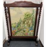 A large VICTORIAN mahogany fire screen with barley twist feature supports with a hand-sewn