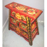 An ORIENTAL HIGHLY decorative yellow painted and floral lacquered red based 3 drawer stool/side