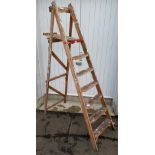 A wooden set of 6 step folding step ladders