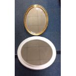 Two oval mirrors one with a white frame 60x50cm, the other gold 65x46cm
