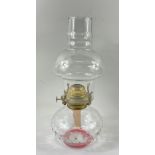 A handy sized vintage oil lamp with dimpled glass base and clear glass shade, stands 30cm tall