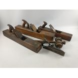 A collection of three antique wooden planes, two large sized dimensions 57cm long each, and one