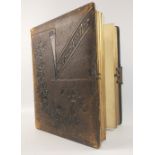 A fascinating glimpse into a former era with this leather-bound photograph album dedicated to Mrs
