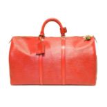 A Louis Vuitton red Epi Keepall 50 luggage bag,