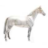 A solid silver model of a horse,