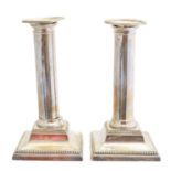 A pair of Edward VII silver candlesticks,