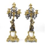 A pair of early 20th-century bronze and ormolu mounted four branch candelabra