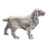 A solid silver model of a spaniel,
