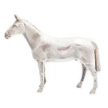 A solid silver model of a horse,