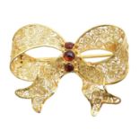 A garnet bow brooch,