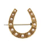 A split pearl horseshoe brooch,