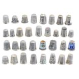 A large selection of silver and white metal thimbles,