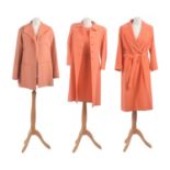 Three orange designer coats,