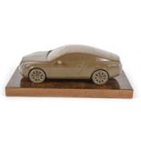bronzed resin desk ornament of a Bentley Continental GT on a lustrous wooden base