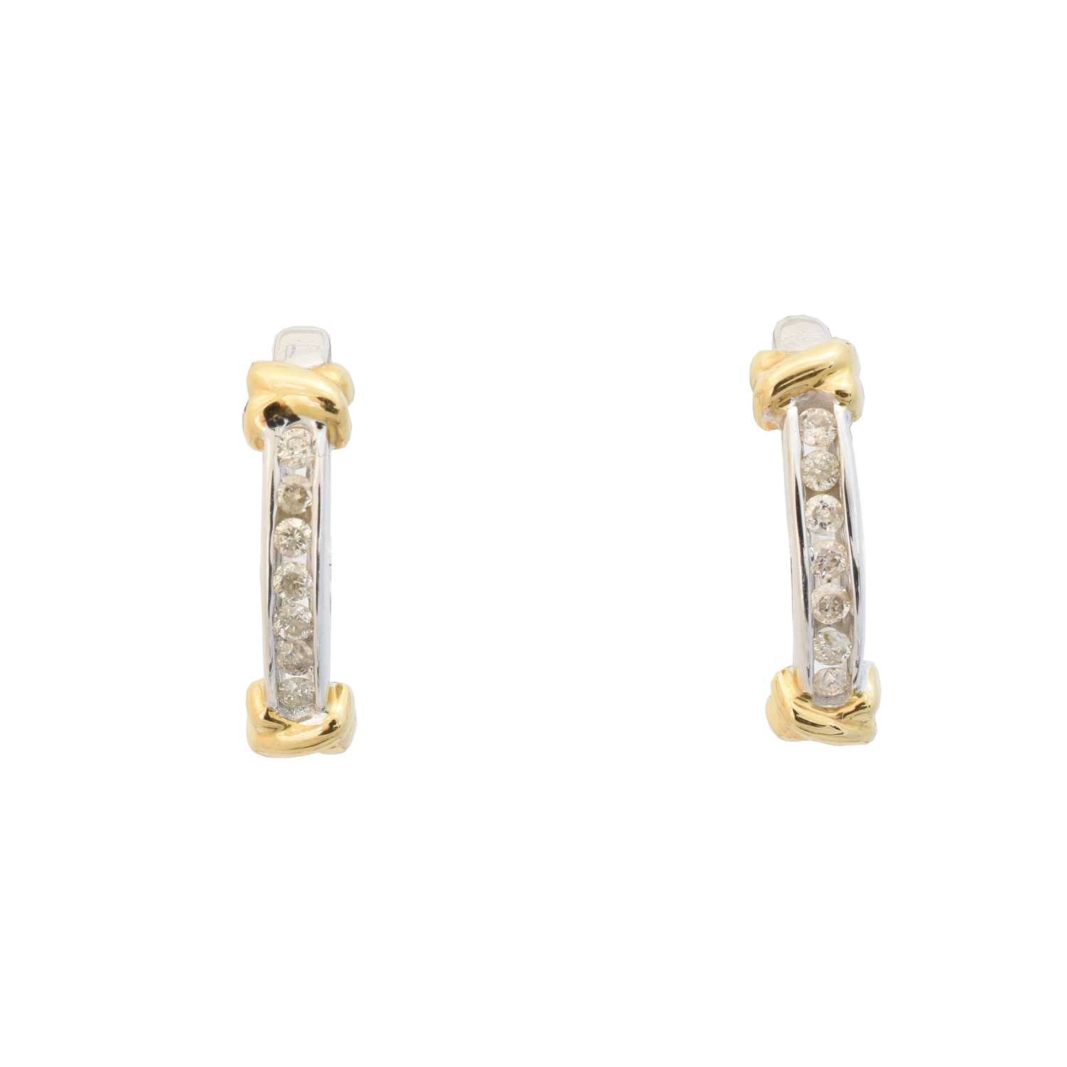 A pair of diamond hoop earrings,