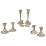 Four pairs of George V and later silver candlesticks,