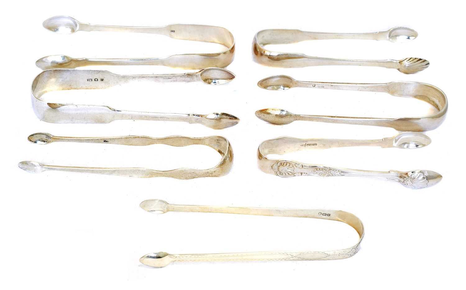 A selection of George III and later silver sugar tongs,