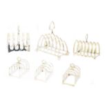 A selection of silver toast racks,