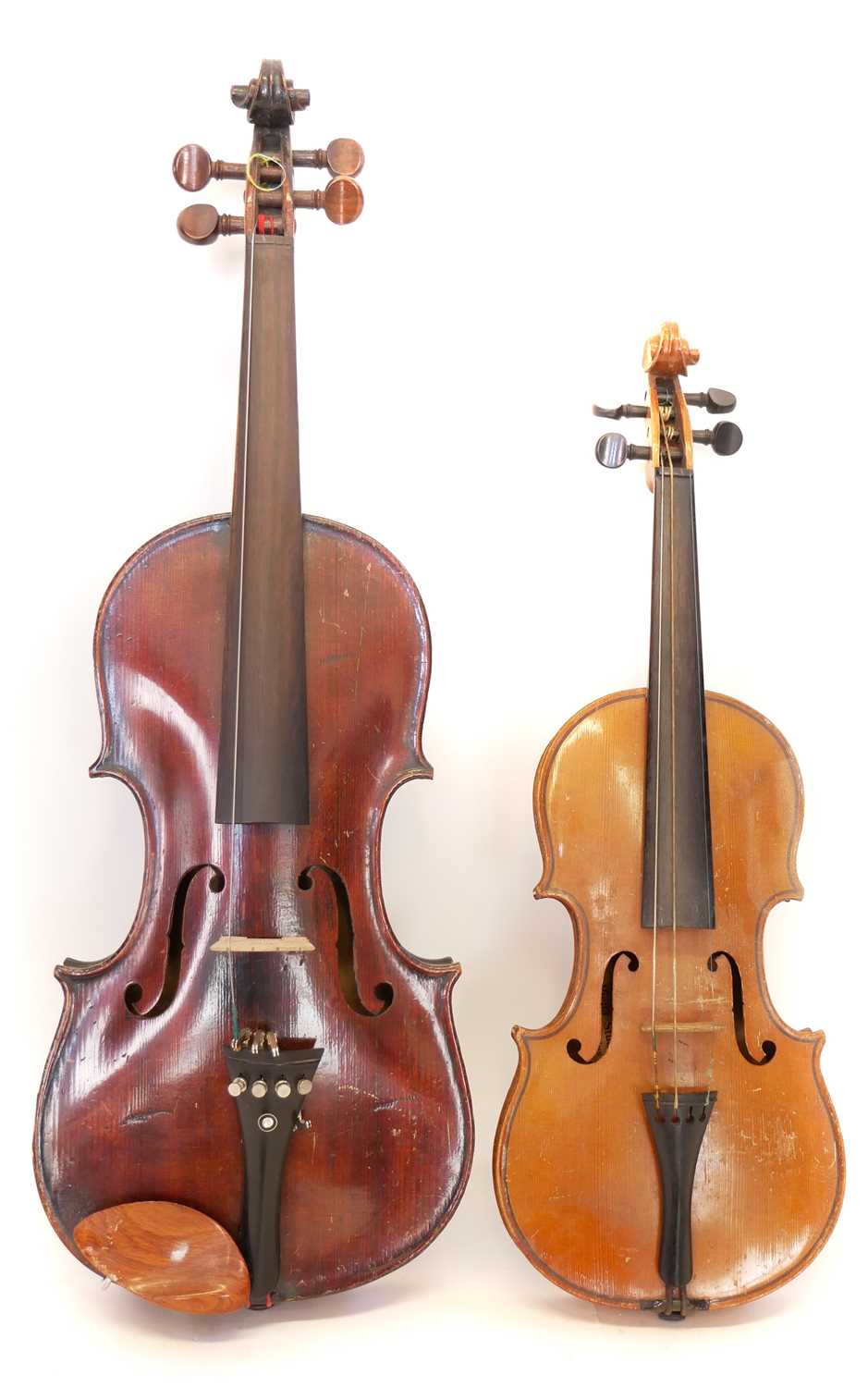 4/4 violin and a 1/2 size violin, each with a bow and case.