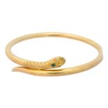 An early 20th century gold emerald and diamond snake bangle,